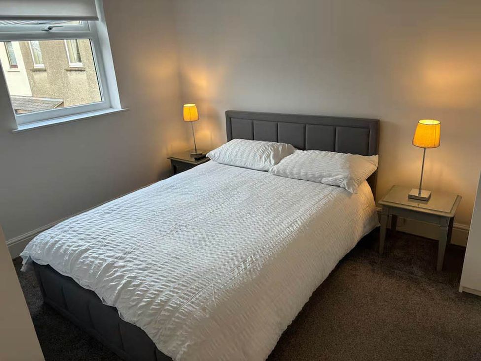A bedroom with a bed and nightstands at the property in location