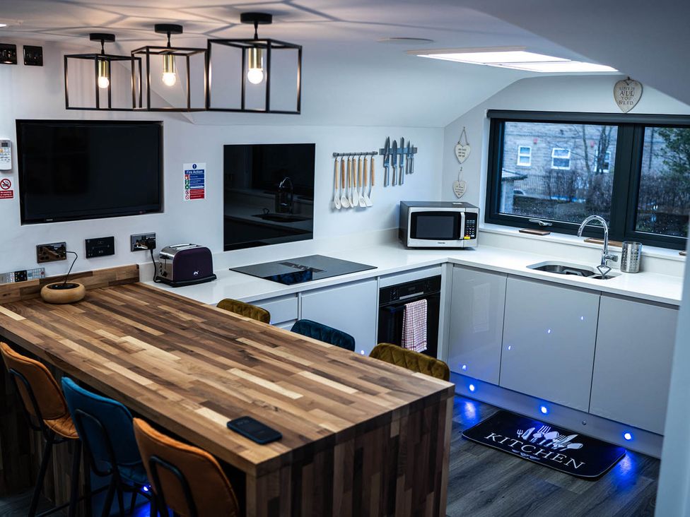 A kitchen with countertop and appliances at The Old Barn in Manchester