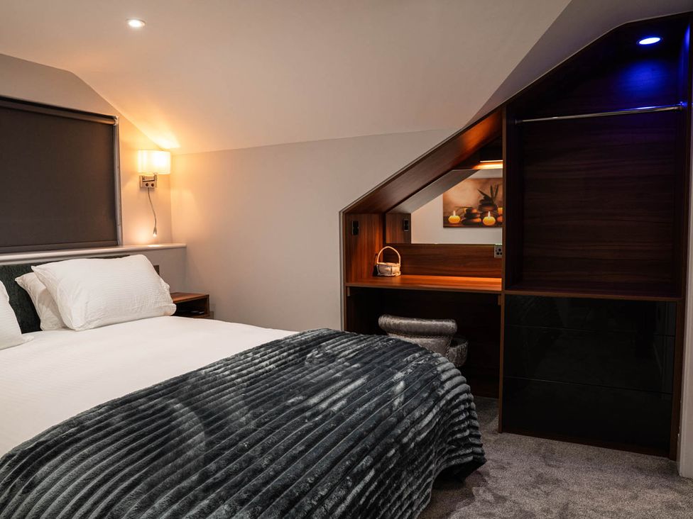A bedroom with a bed and a desk at 