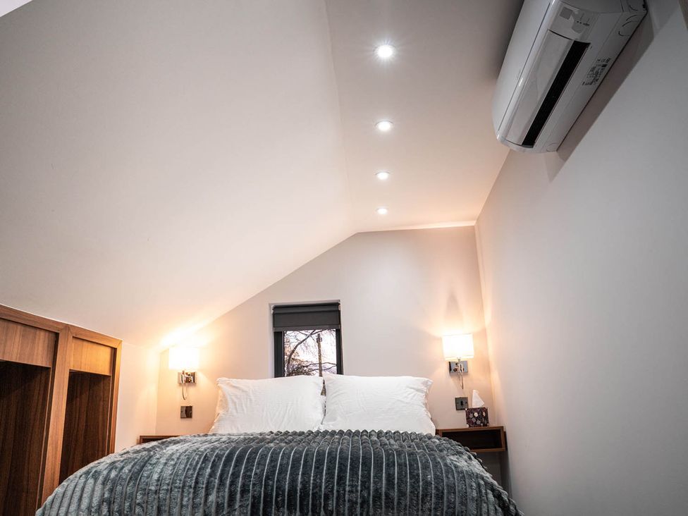 A bedroom with a bed and bedside table at the property