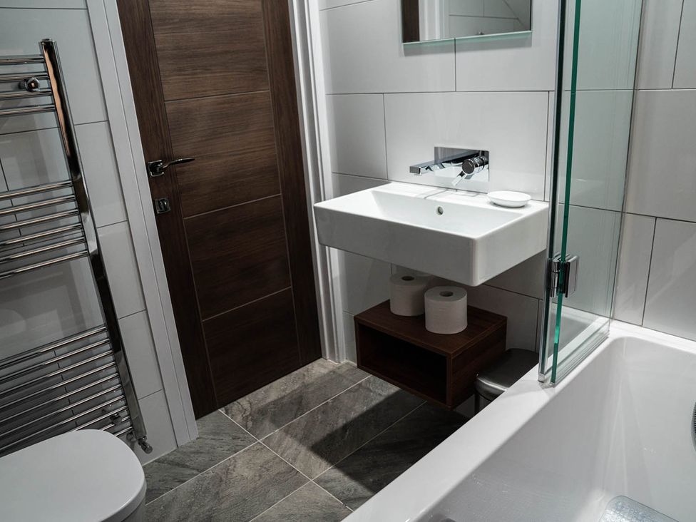 A bathroom with a sink and shower at The Old Barn in Manchester