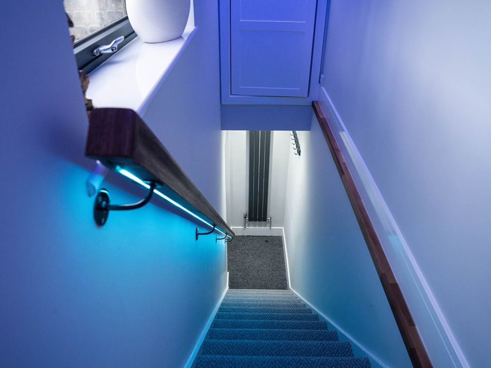 A staircase with a handrail and door at 