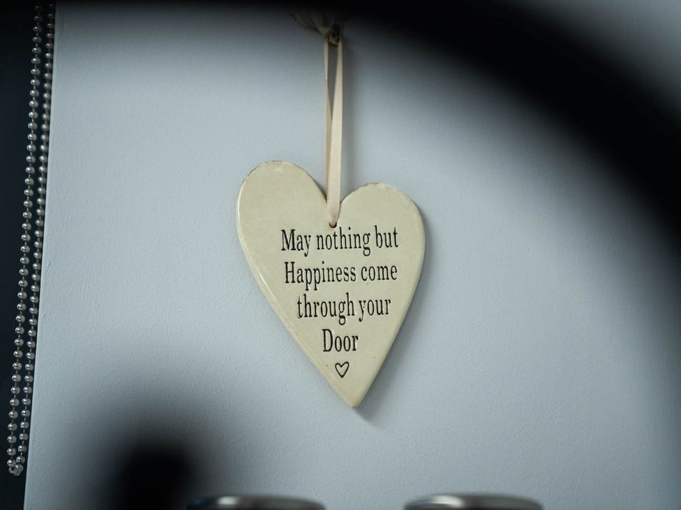 A heart decoration with a message hanging on a wall