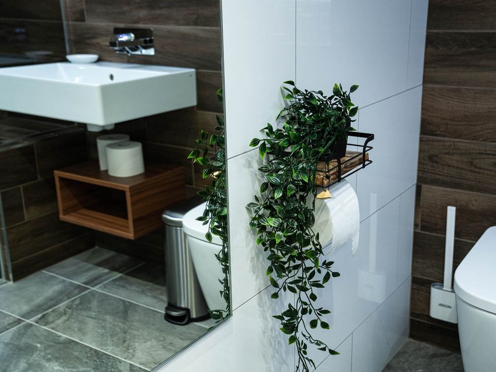 A bathroom featuring a sink, toilet, and storage at the property in 