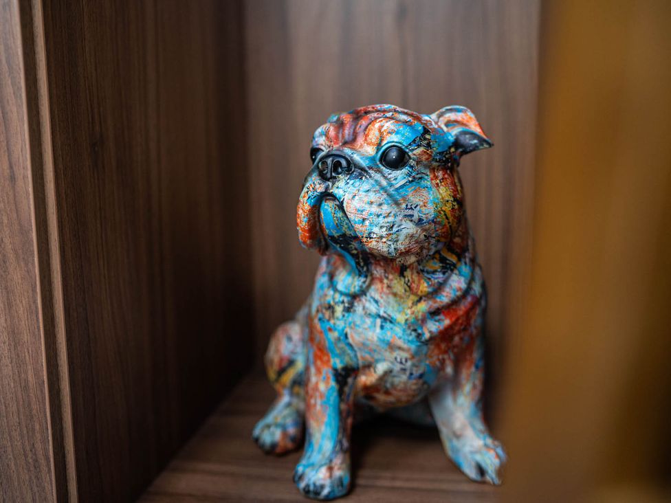 A dog sculpture on a shelf at 
