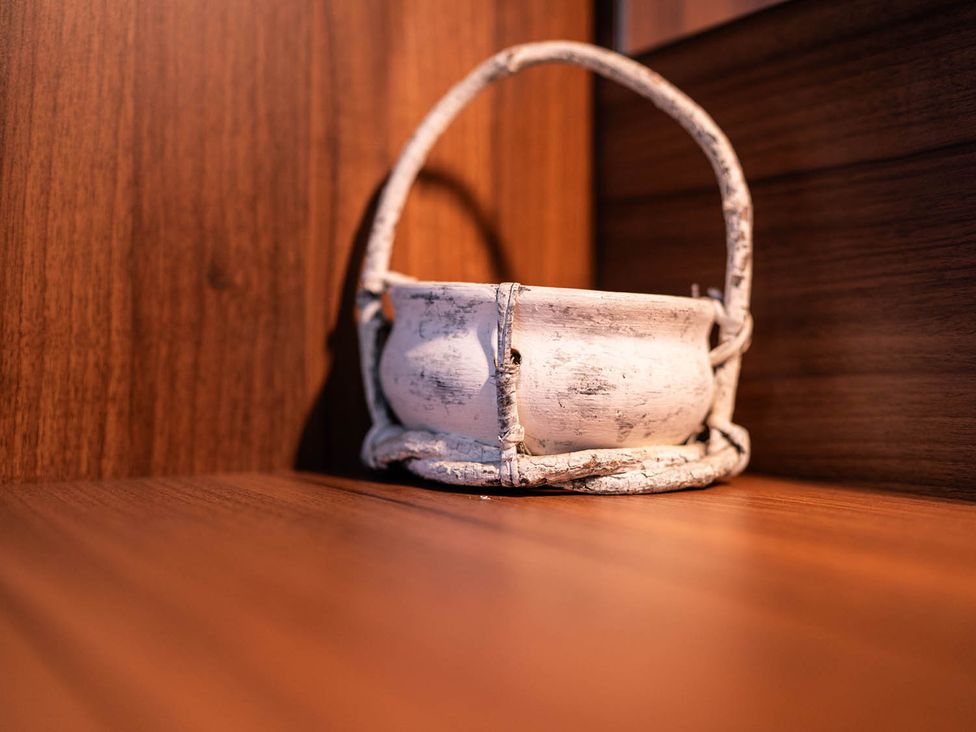 A pot on a wooden shelf