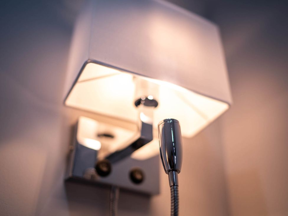 A wall lamp with a light shade and switch