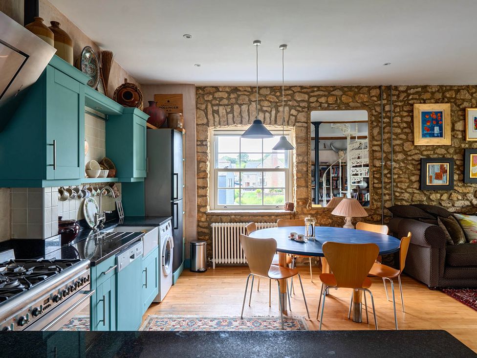 A kitchen with a dining table and chairs at Beautiful Pad Near World Heritage Jurassic Coast in Pymore near Bridport