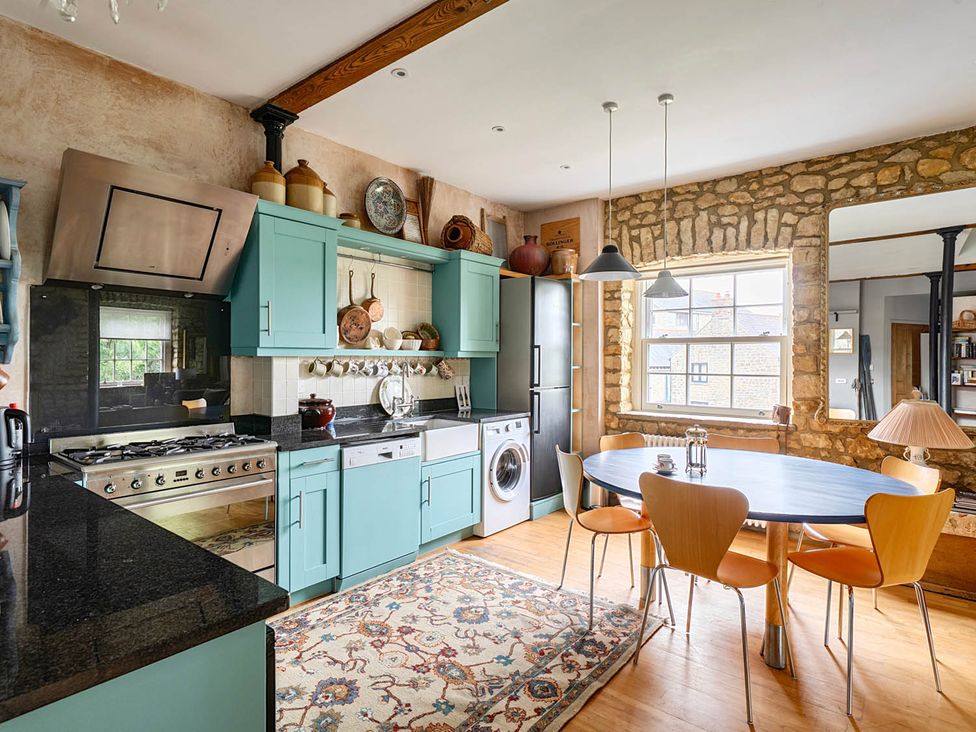 A kitchen with a table and chairs at Beautiful Pad Near World Heritage Jurassic Coast in Pymore near Bridport