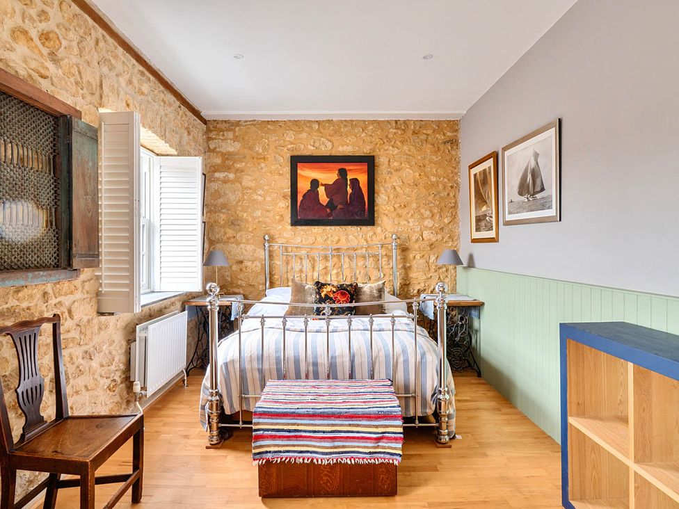 A bedroom with a bed and chair at Beautiful Pad Near World Heritage Jurassic Coast in Pymore near Bridport