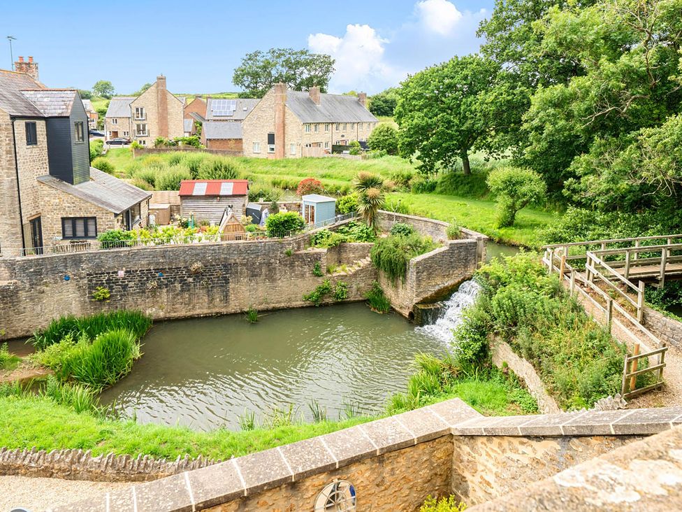 A view of houses and water with a bridge at Beautiful Pad Near World Heritage Jurassic Coast in Pymore near Bridport