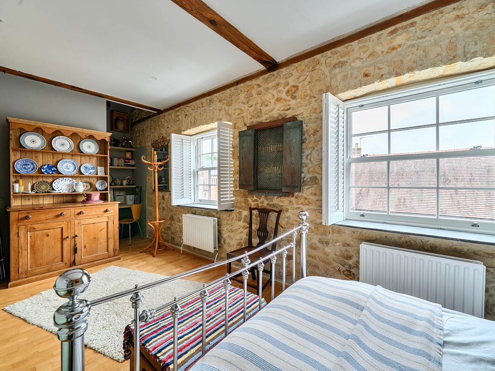 A bedroom with a bed and wooden furniture at Beautiful Pad Near World Heritage Jurassic Coast Pymore near Bridport