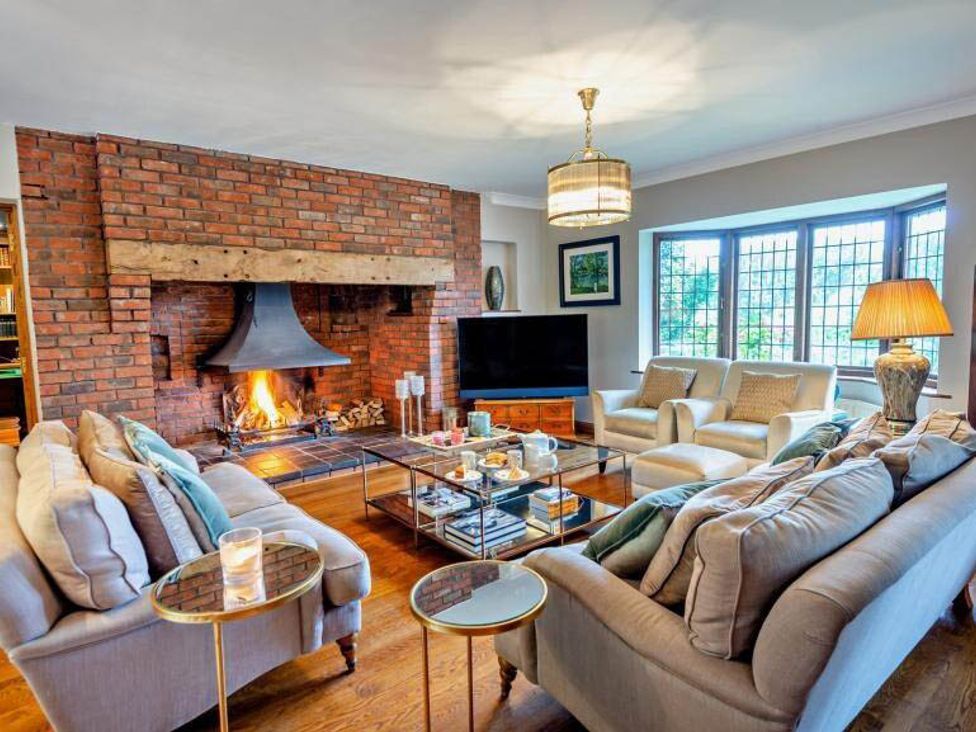 A living room with a fireplace, sofas, and a television at Luxurious 5 Bedroom House in Cookham near Marlow