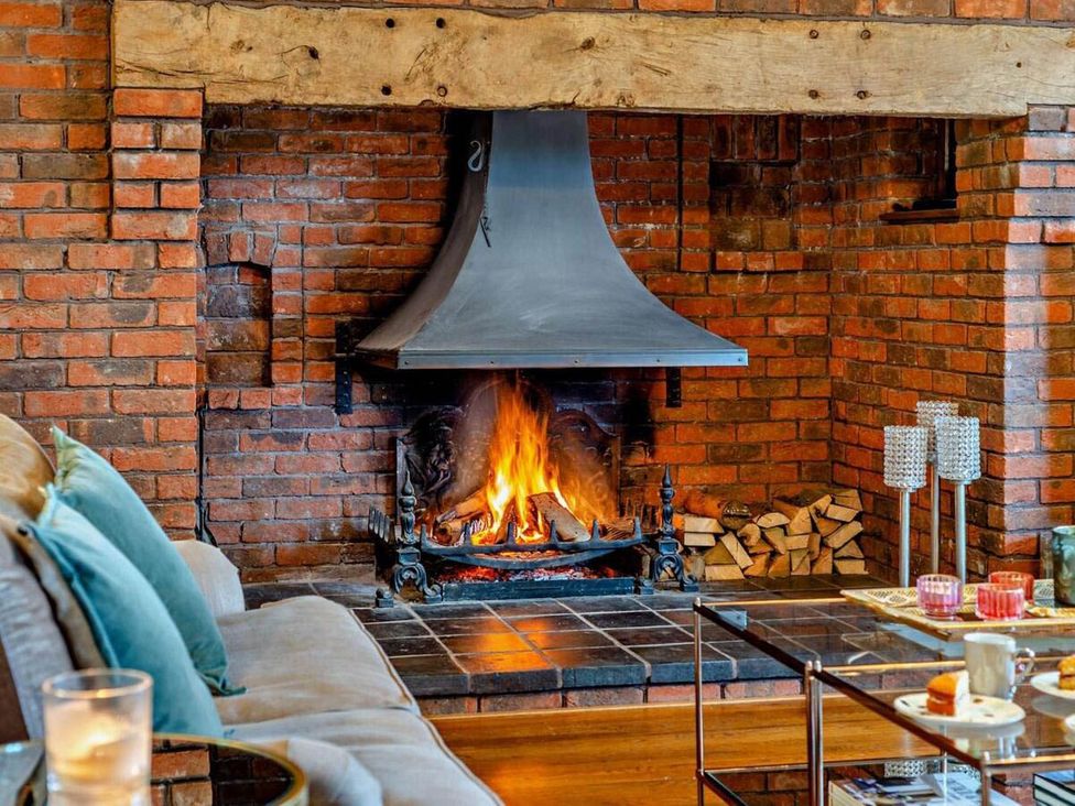 A living room with a fireplace and sofa at Luxurious 5 Bedroom House in Cookham near Marlow