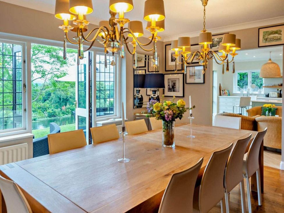 A dining room with a large table and chandelier at Luxurious 5 Bedroom House in Cookham near Marlow