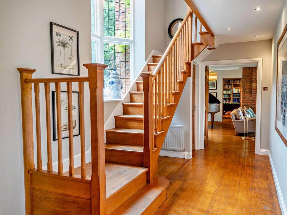 A hallway with a staircase and decorative items at Luxurious 5 Bedroom House in Cookham near Marlow