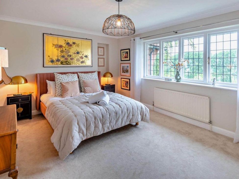 A bedroom with a bed, artwork on the wall and a window at Luxurious 5 Bedroom House in Cookham near Marlow