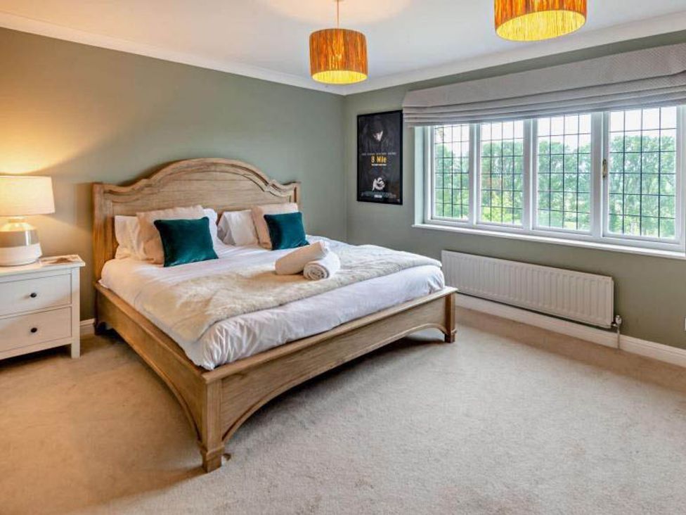 A bedroom with a bed and nightstand at Luxurious 5 Bedroom House in Cookham near Marlow