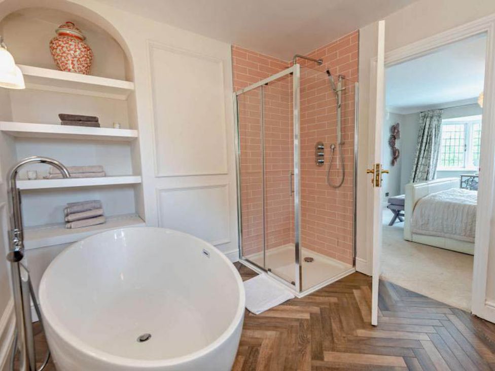 A bathroom with a bathtub and shower at Luxurious 5 Bedroom House in Cookham near Marlow