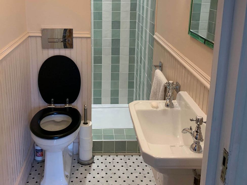 A bathroom with toilet, sink, and shower at Luxurious 5 Bedroom House in Cookham near Marlow