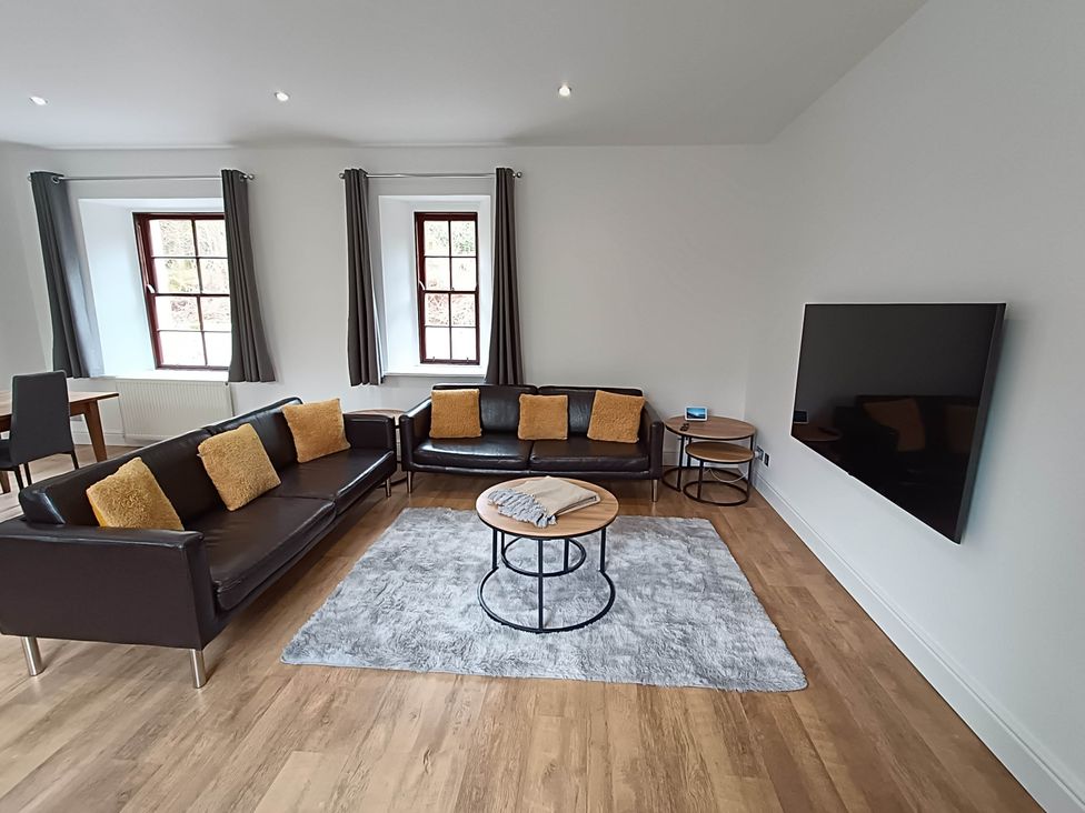 A living room with a sofa and coffee table at RnB Rural n Beautiful near Barrhill