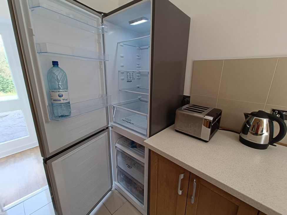 A kitchen with a refrigerator, toaster, and kettle at RnB Rural n Beautiful Near Barrhill