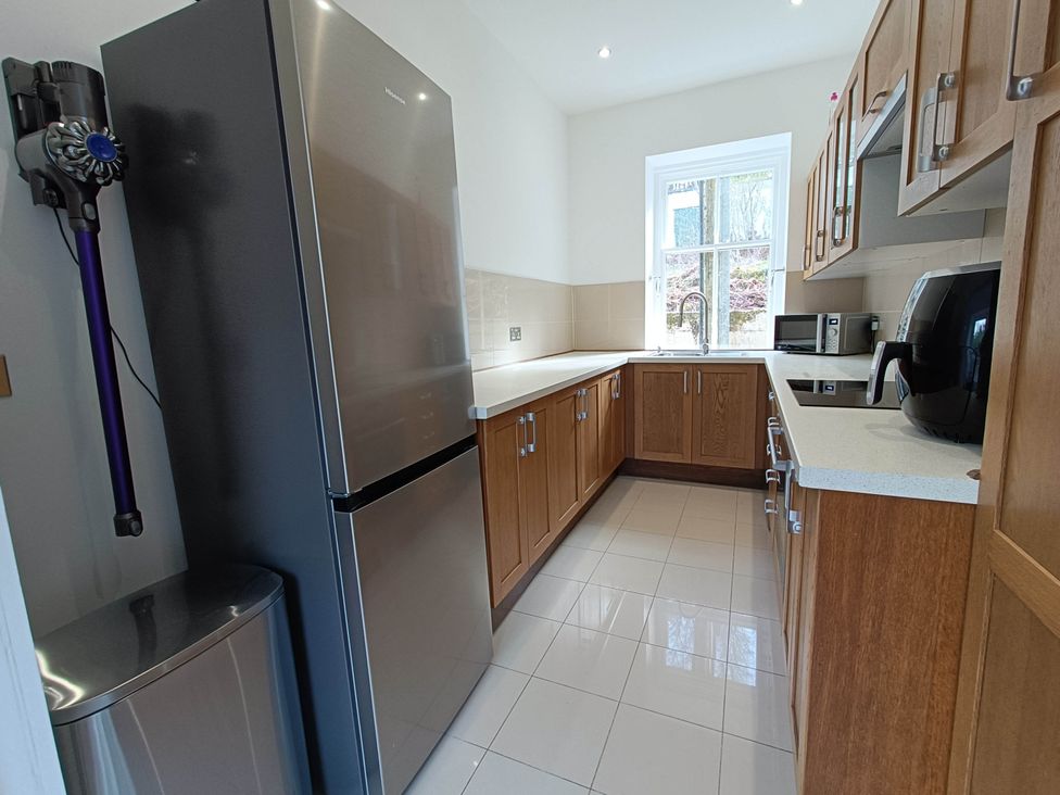 A kitchen with a fridge, sink, and microwave at RnB Rural n Beautiful Near Barrhill