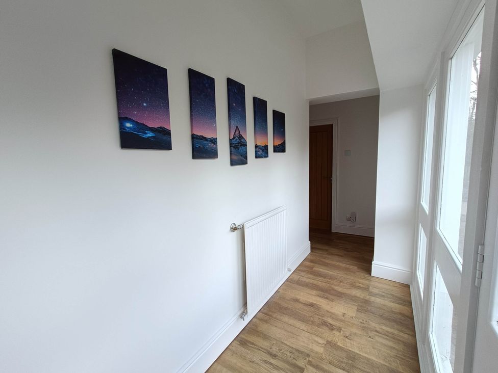 A hallway with wall art and a radiator at RnB Rural n Beautiful Near Barrhill