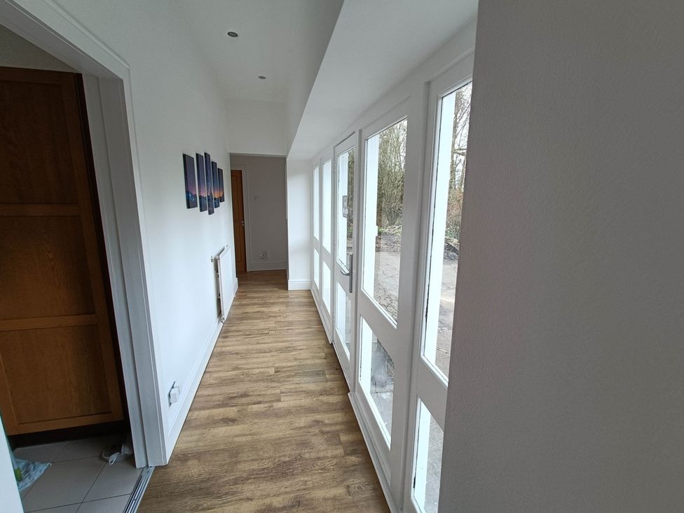 A hallway with pictures on the wall at RnB Rural n Beautiful Near Barrhill