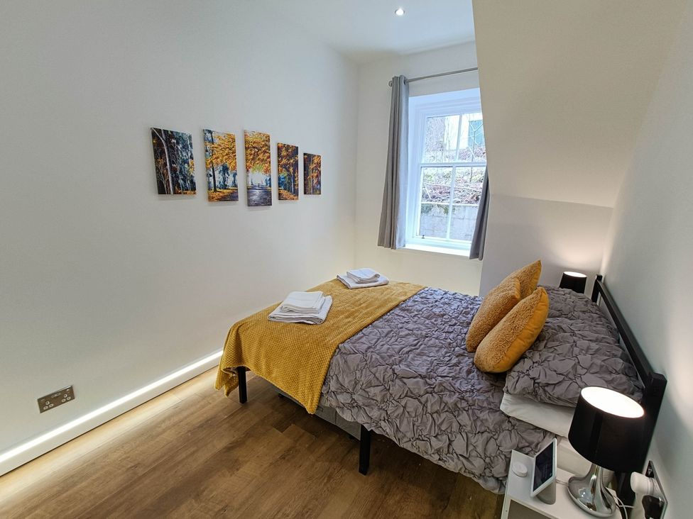 A bedroom with a bed and wall art at RnB Rural n Beautiful Near Barrhill