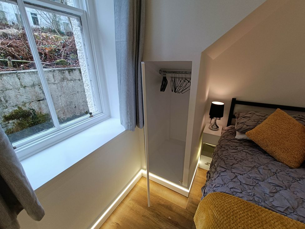 A bedroom with a bed, window, and closet at RnB Rural n Beautiful Near Barrhill
