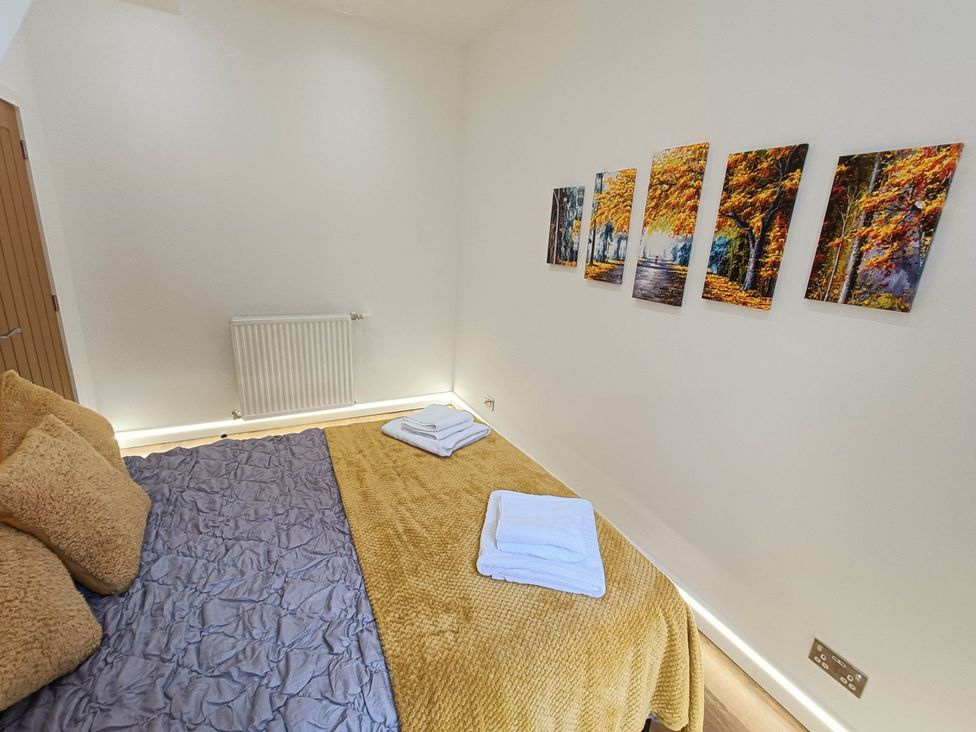 A bedroom with a bed and wall art at RnB Rural n Beautiful Near Barrhill