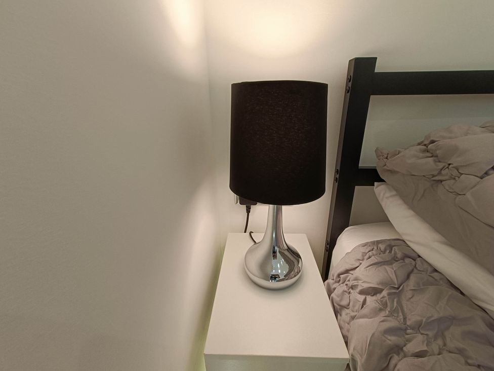 A lamp on a bedside table at RnB Rural n Beautiful near Barrhill
