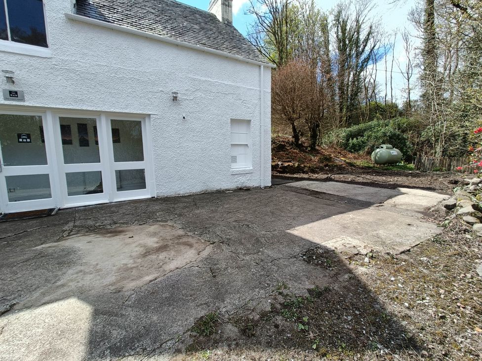 An outdoor area with a building and concrete surface at RnB Rural n Beautiful Near Barrhill