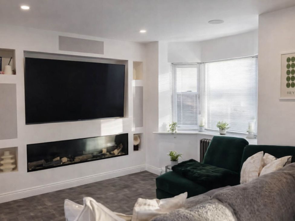 A living room with a television and fireplace at Hot tub  BBQ  Garden Parking  Sleeps 8 Worcester