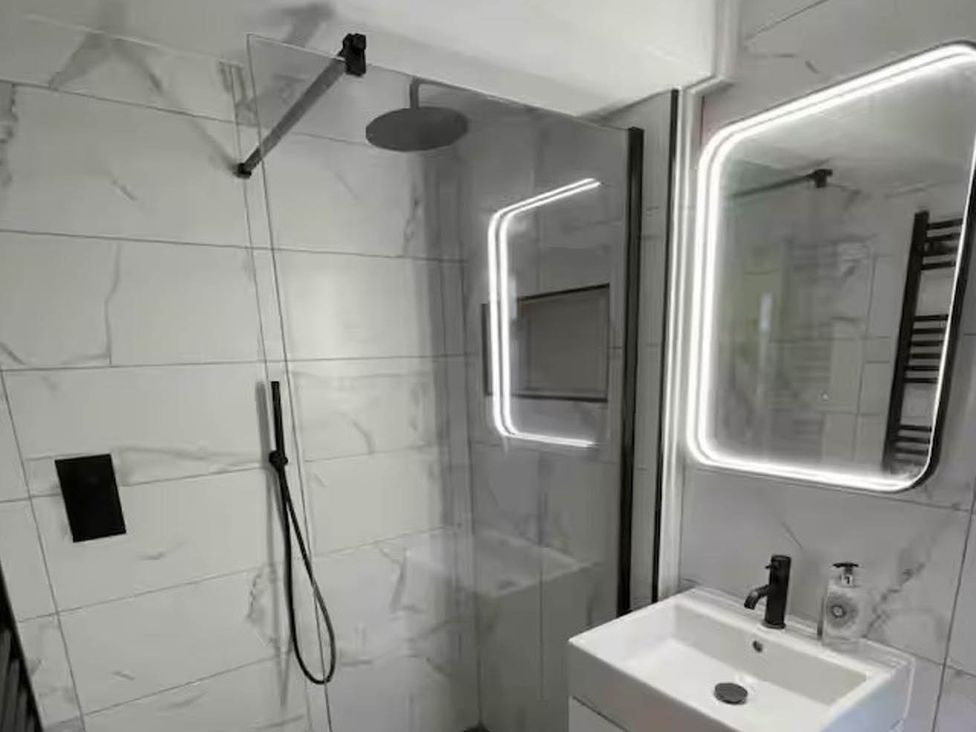 A bathroom with a shower and sink at Hot tub  BBQ  Garden Parking  Sleeps 8 Worcester