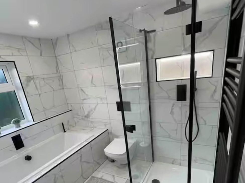 A bathroom with a bathtub, shower, and toilet at Hot tub  BBQ  Garden Parking  Sleeps 8 Worcester