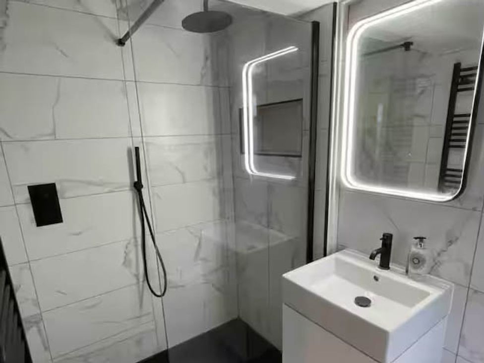 A bathroom with a shower and a vanity sink at Hot tub  BBQ  Garden Parking  Sleeps 8 in Worcester