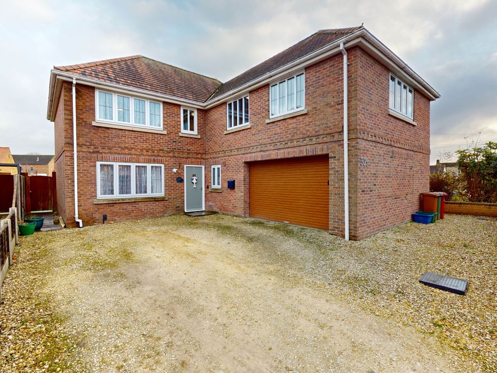 A house with a garage and driveway at 5 Bedroom Home Sleeps 16 Ideal for Groups in Epworth