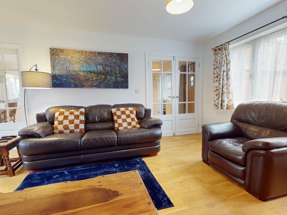 A living room with a sofa and armchair at 5 Bedroom Home Sleeps 16 Ideal for Groups in Epworth