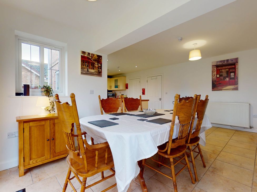 A dining room with a table and chairs at 5 Bedroom Home Sleeps 16 Ideal for Groups in Epworth