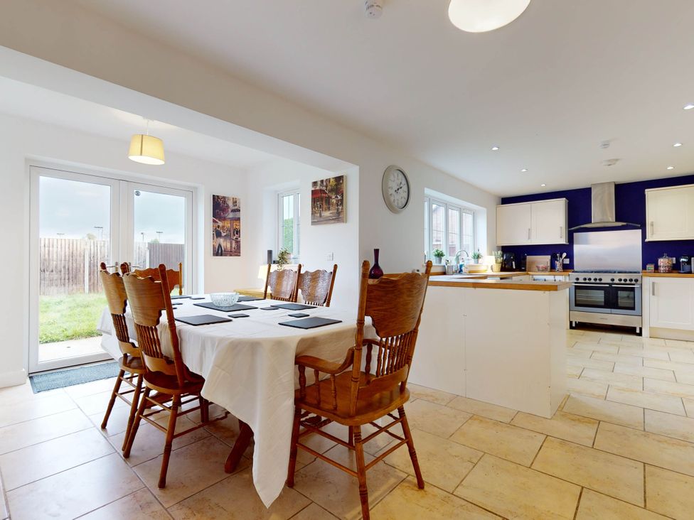 A kitchen with a dining table and chairs at 5 Bedroom Home Sleeps 16 Ideal for Groups in Epworth