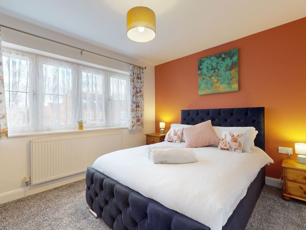 A bedroom with a bed and bedside tables at 5 Bedroom Home Sleeps 16 Ideal for Groups in Epworth
