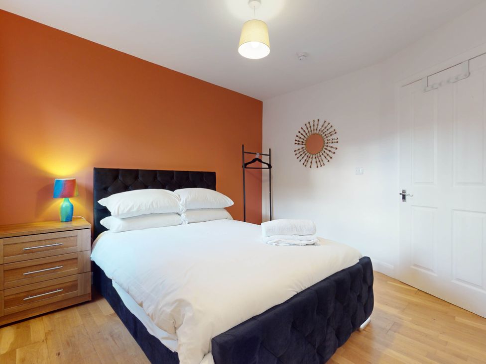 A bedroom with a bed and a lamp at 5 Bedroom Home Sleeps 16 Ideal for Groups in Epworth
