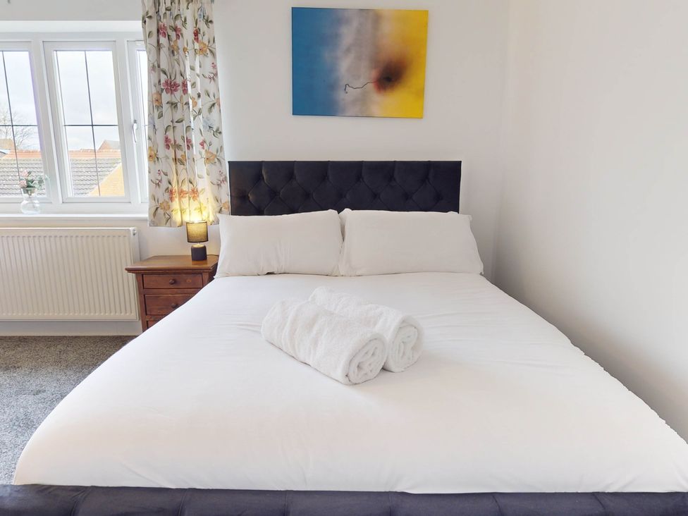 A bedroom with a bed and pillows at 5 Bedroom Home Sleeps 16 Ideal for Groups in Epworth