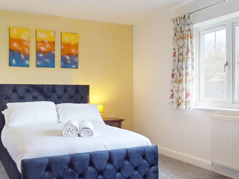 A bedroom with a bed and wall art at 5 Bedroom Home Sleeps 16 Ideal for Groups in Epworth