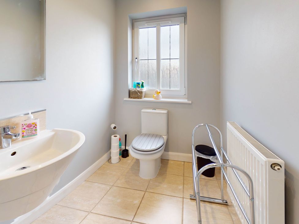 A bathroom with a toilet and sink at 5 Bedroom Home Sleeps 16 Ideal for Groups in Epworth