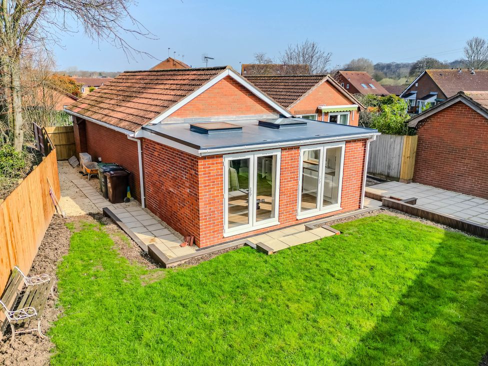 A bungalow with patio and grass area at Loughborough Luxe Bungalow Retreat Sleeps 6 in Shepshed