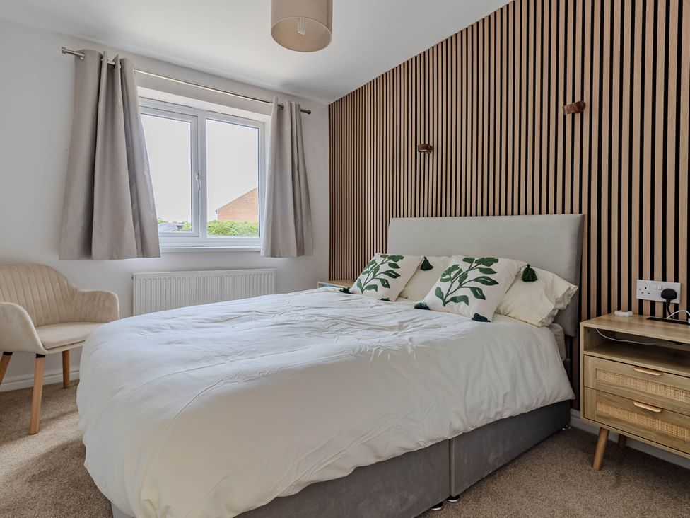 A bedroom with a bed and nightstand at Loughborough Luxe Bungalow Retreat Sleeps 6 in Shepshed