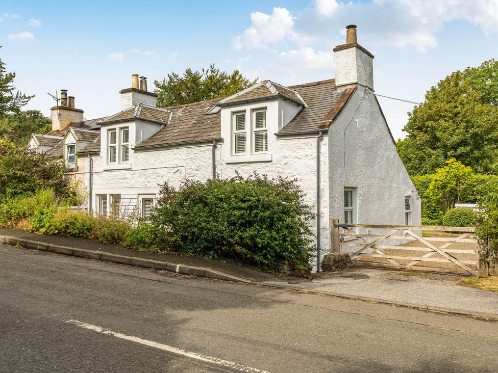 A house with a gate and bushes at House Sleeps 6 Pet Friendly Parking Auchencairn near Palnackie